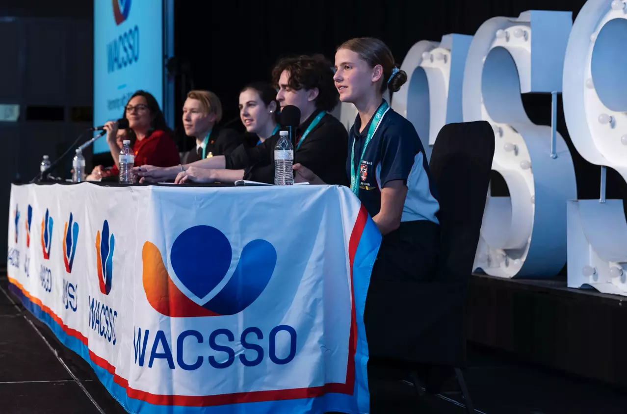 Students speaking at education event representing education sector